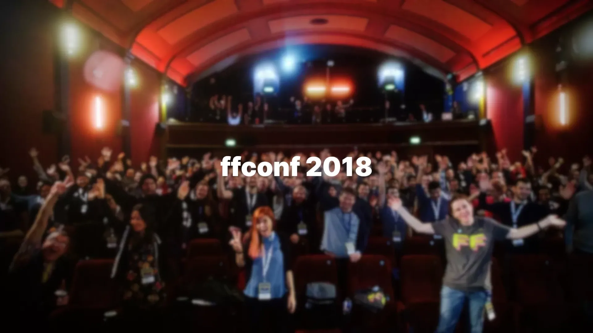 The audience of ffconf jumping and cheering in a theatre